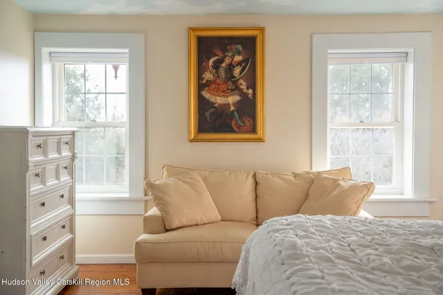 a bedroom with a bed and a mirror