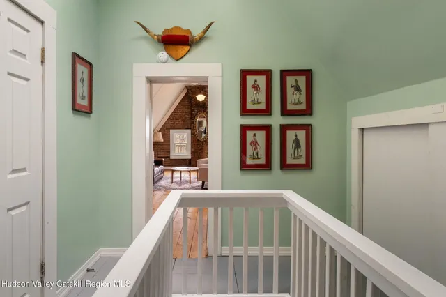 a living room with furniture a dining table and wooden floor