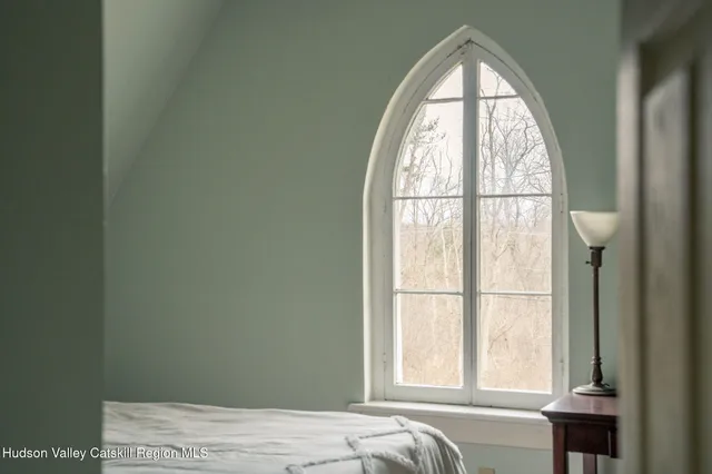 a bedroom with two beds and a large window
