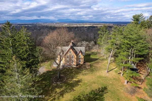 an aerial view of a house with a yard basket ball court and outdoor seating