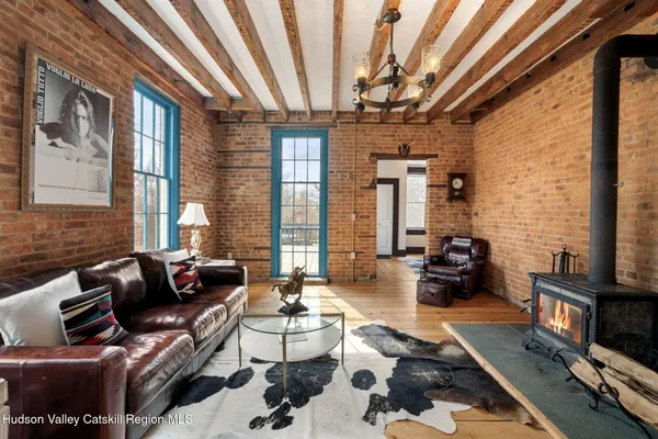 a living room with furniture and a floor to ceiling window