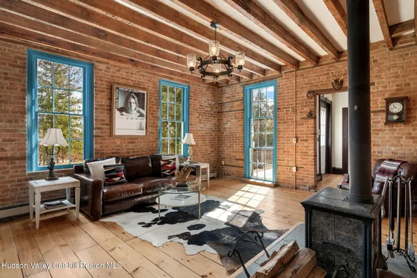 a living room with furniture and large windows