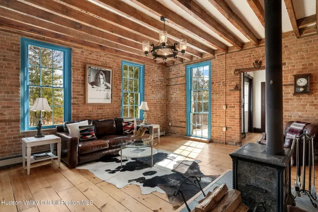 a living room with furniture and large windows