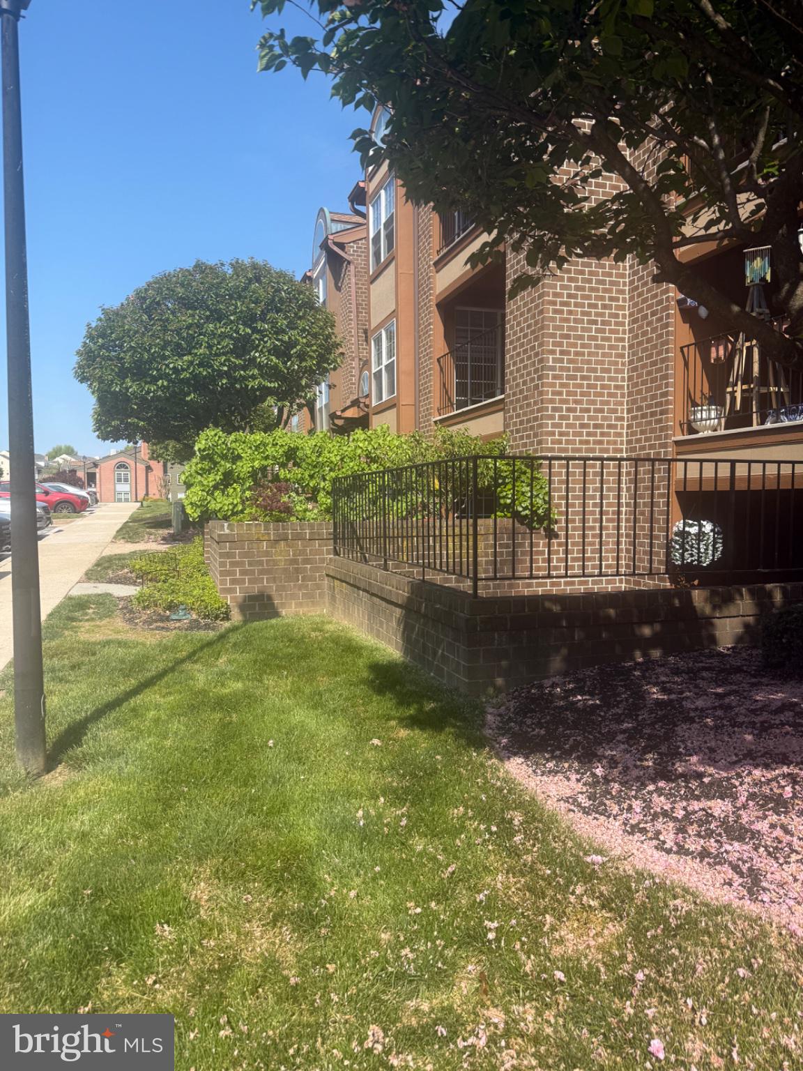 2101 Woodbox Lane, Unit B Baltimore, MD 21209 - Photo 2 of 21 Charming brick facade with lush greenery.