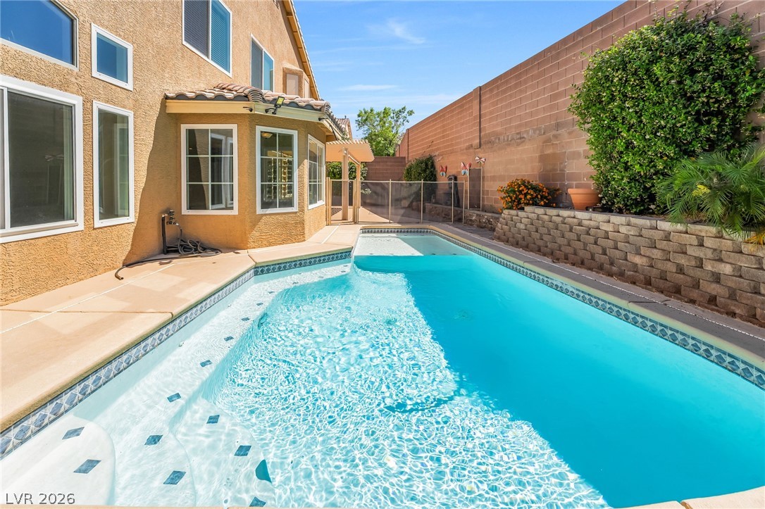271 Pointe Ranier Avenue Henderson, NV 89012 - Photo 26 of 26 This private pool area offers a refreshing escape, perfect for relaxation and outdoor enjoyment.