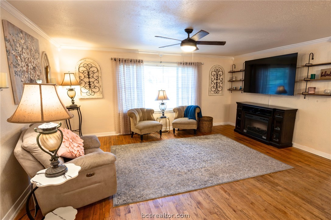 749 South Cass Street Centerville, TX 75833 - Photo 3 of 30 a living room with furniture a flat screen tv and a fireplace