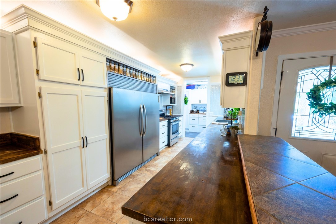 749 South Cass Street Centerville, TX 75833 - Photo 9 of 30 a view of a kitchen with wooden floor and a refrigerator