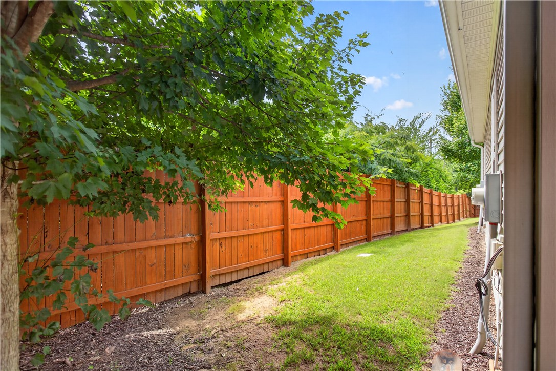 235 Pendleton Road, Unit K1 Clemson, SC 29631 - Photo 5 of 49 Secure yard featuring a well-maintained wood fence, providing privacy and a verdant backdrop.