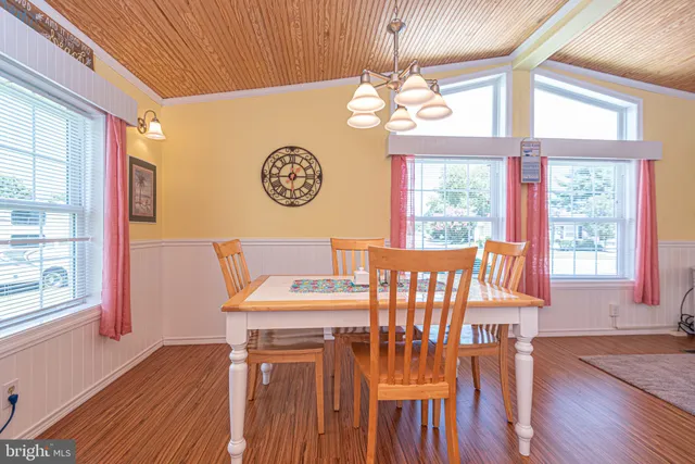 a view of a dining room with furniture wooden floor and chandelier