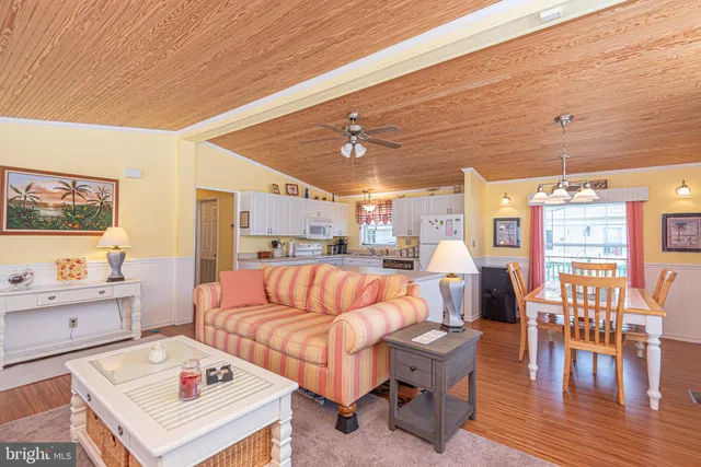 a living room with furniture and kitchen view