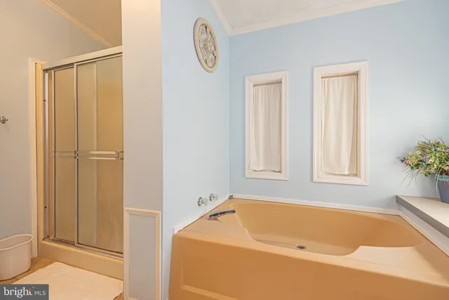 a bathroom with a tub and shower