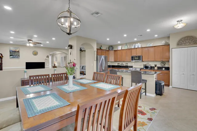 a large kitchen with a table and chairs