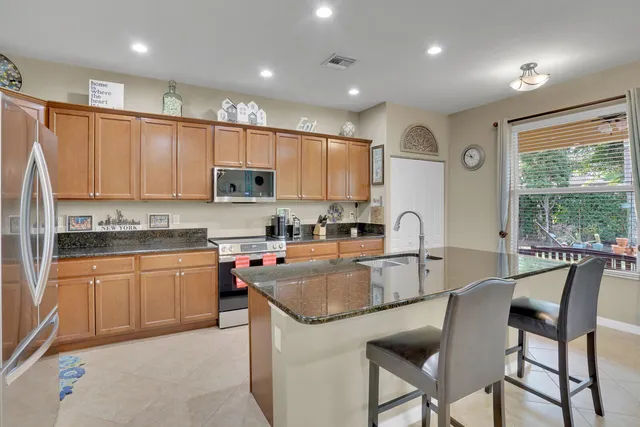 a kitchen with granite countertop a sink and appliances