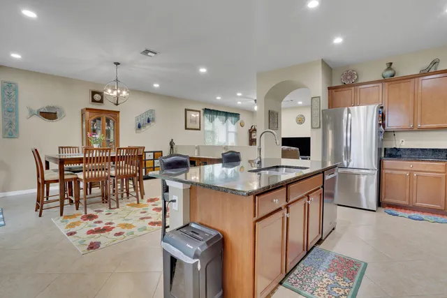 a kitchen with stainless steel appliances kitchen island granite countertop a sink and cabinets