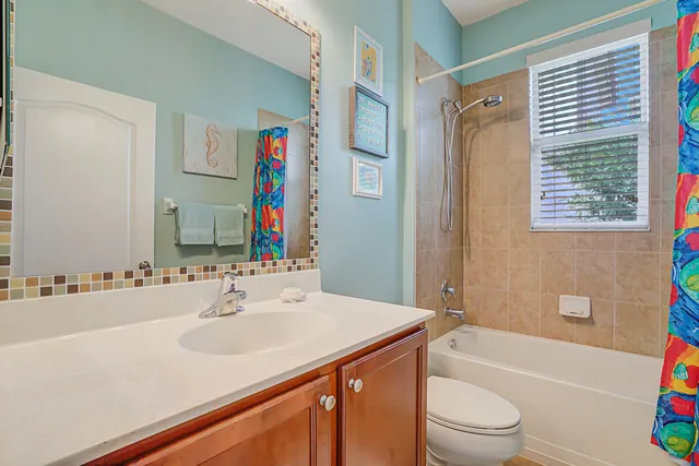 a bathroom with a sink a toilet a tub and shower