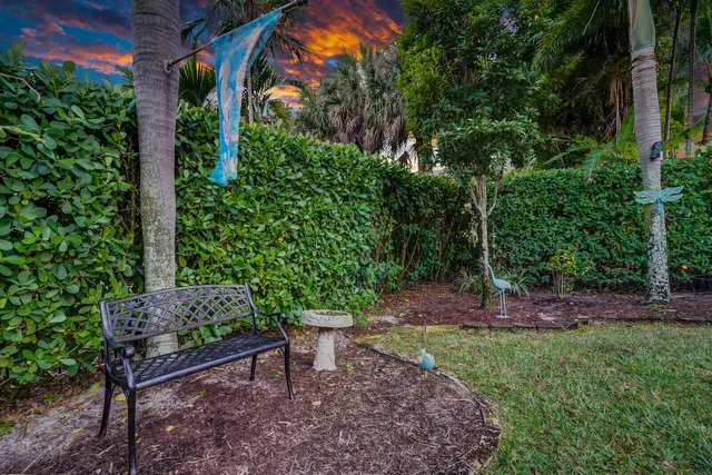 a patio with glass top table and chairs