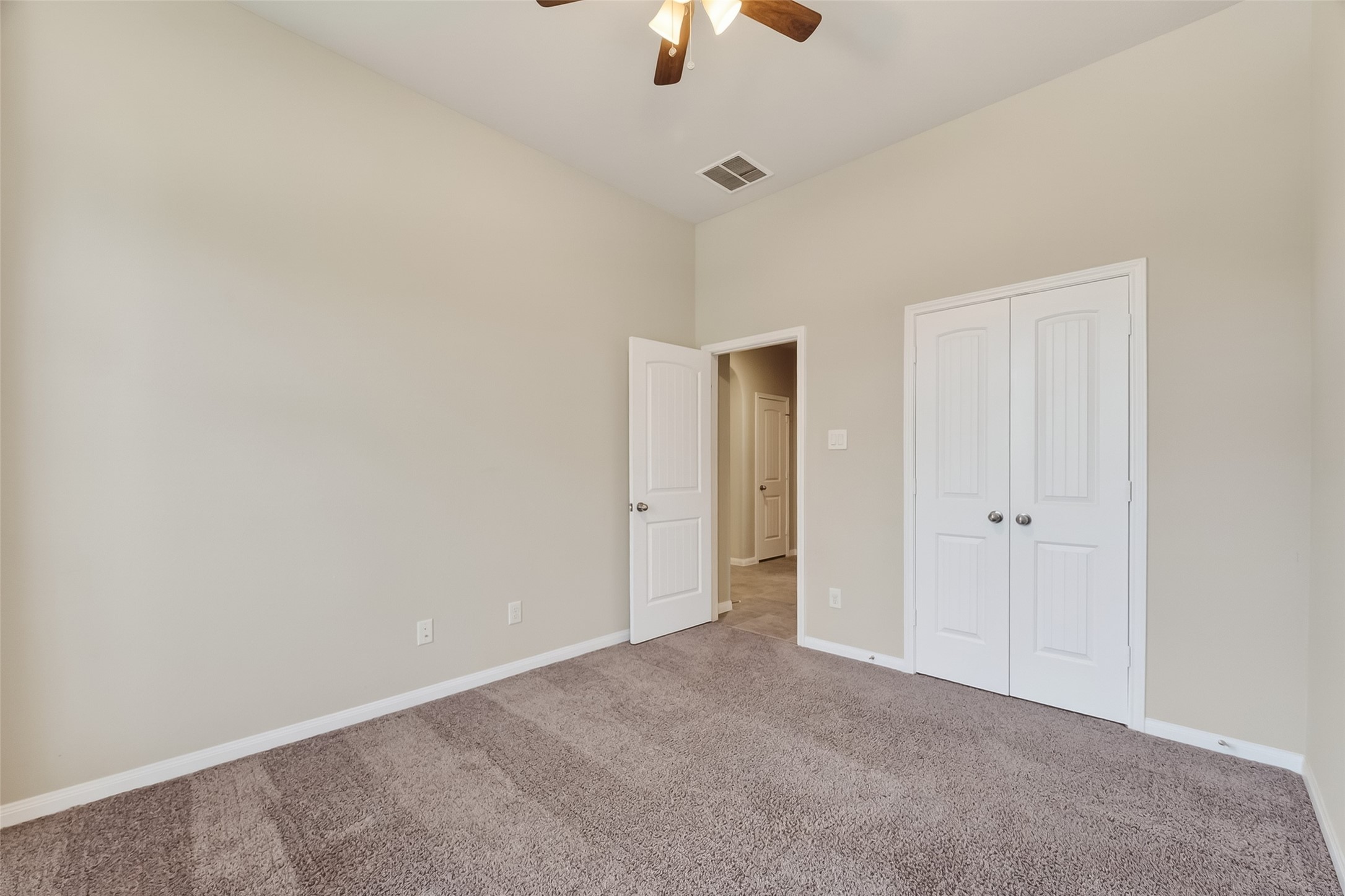 5 Lucas Chase Court Manvel, TX 77578 - Photo 26 of 50 With 10-foot ceilings and a ceiling fan overhead, this second bedroom feels airy and open—ready to keep you cool, focused, or well-rested, no matter how you choose to use the space.