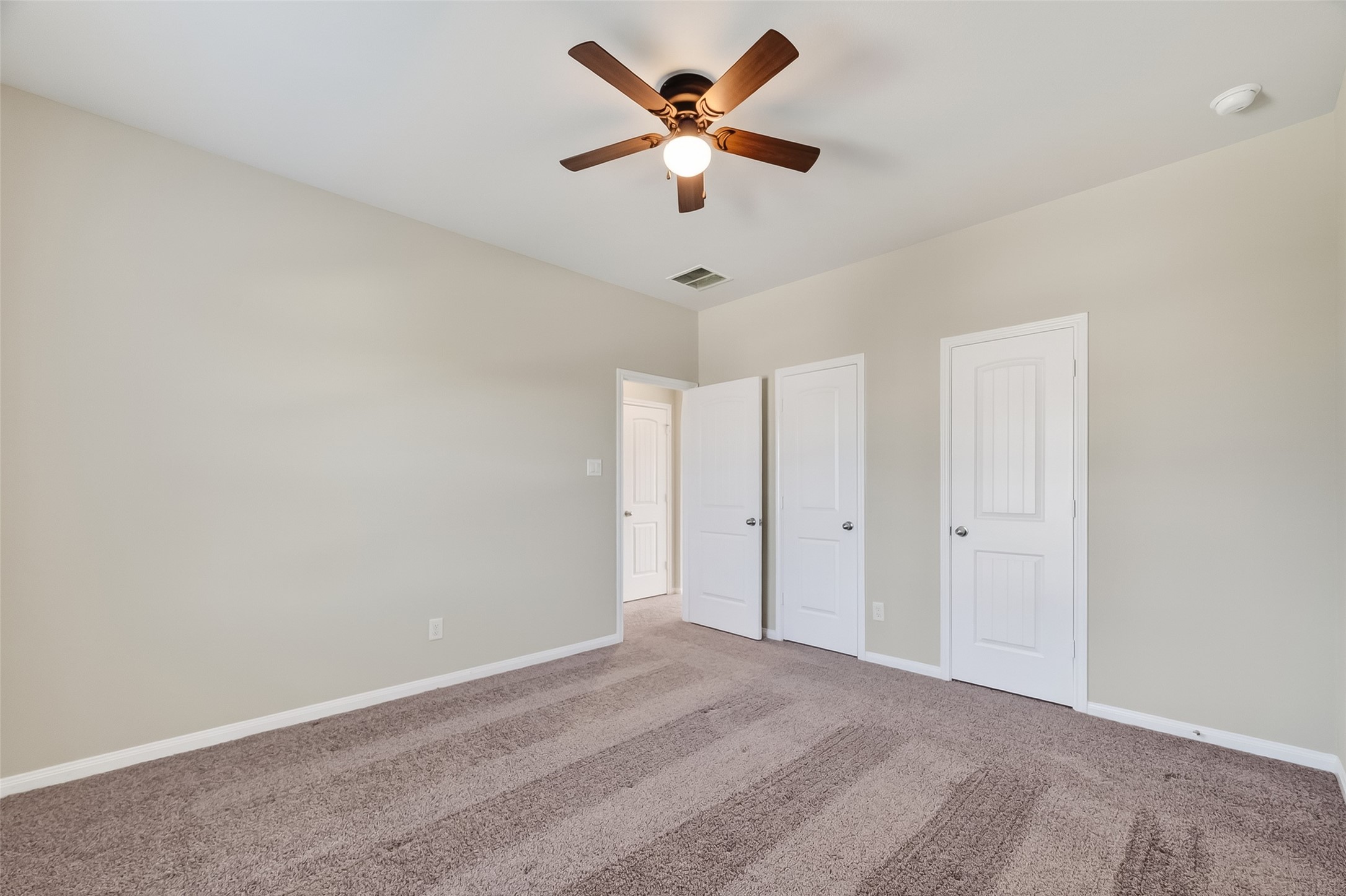 5 Lucas Chase Court Manvel, TX 77578 - Photo 33 of 50 This upstairs bedroom offers plenty of room to stretch out, with a spacious layout, ceiling fan, natural light, and a second entry door for added convenience—plus a long closet to keep everything tucked away .