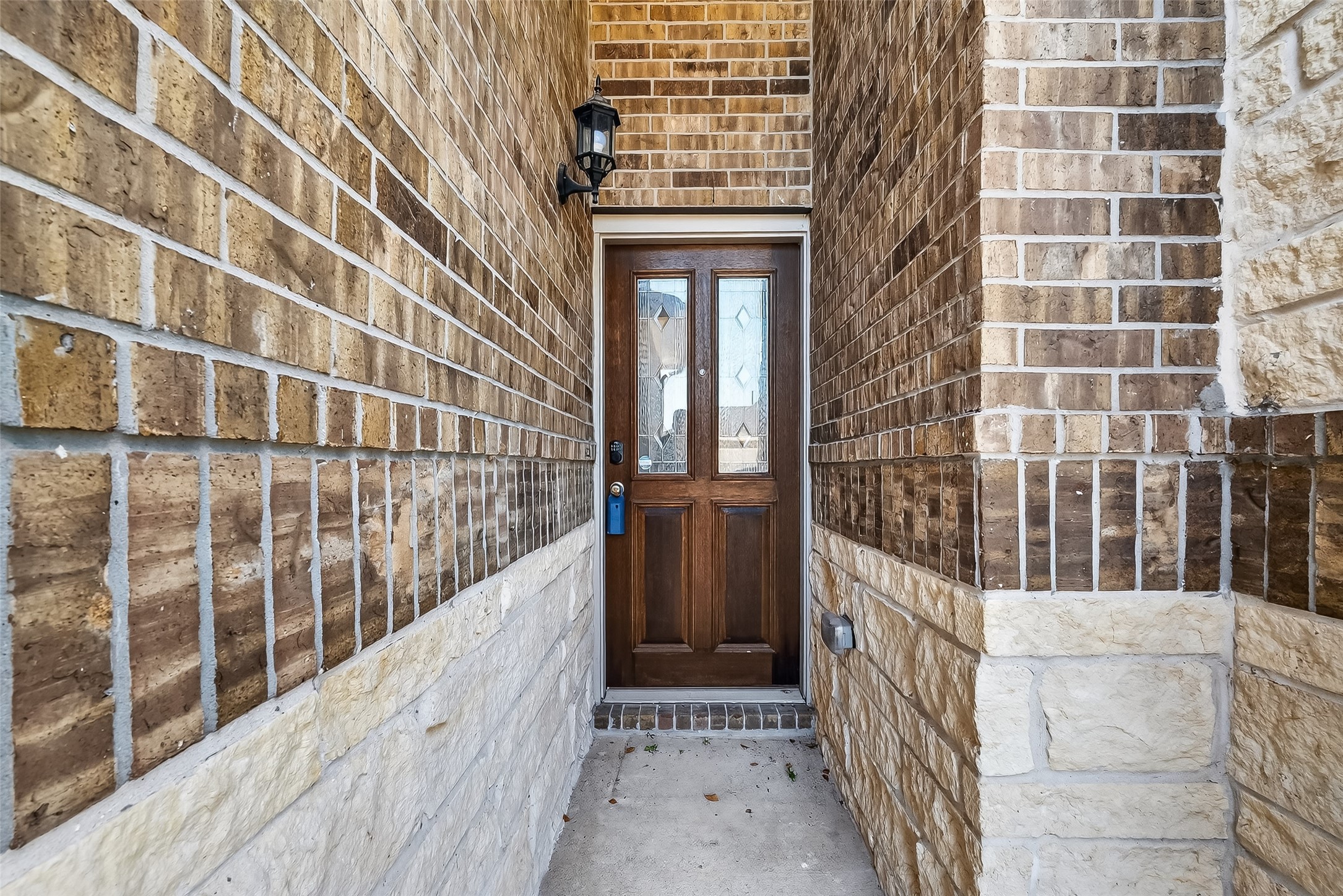 5 Lucas Chase Court Manvel, TX 77578 - Photo 4 of 50 Step up to your private front entry framed by rich brickwork and a charming wood door—this inviting welcome sets the tone for the comfort waiting inside.