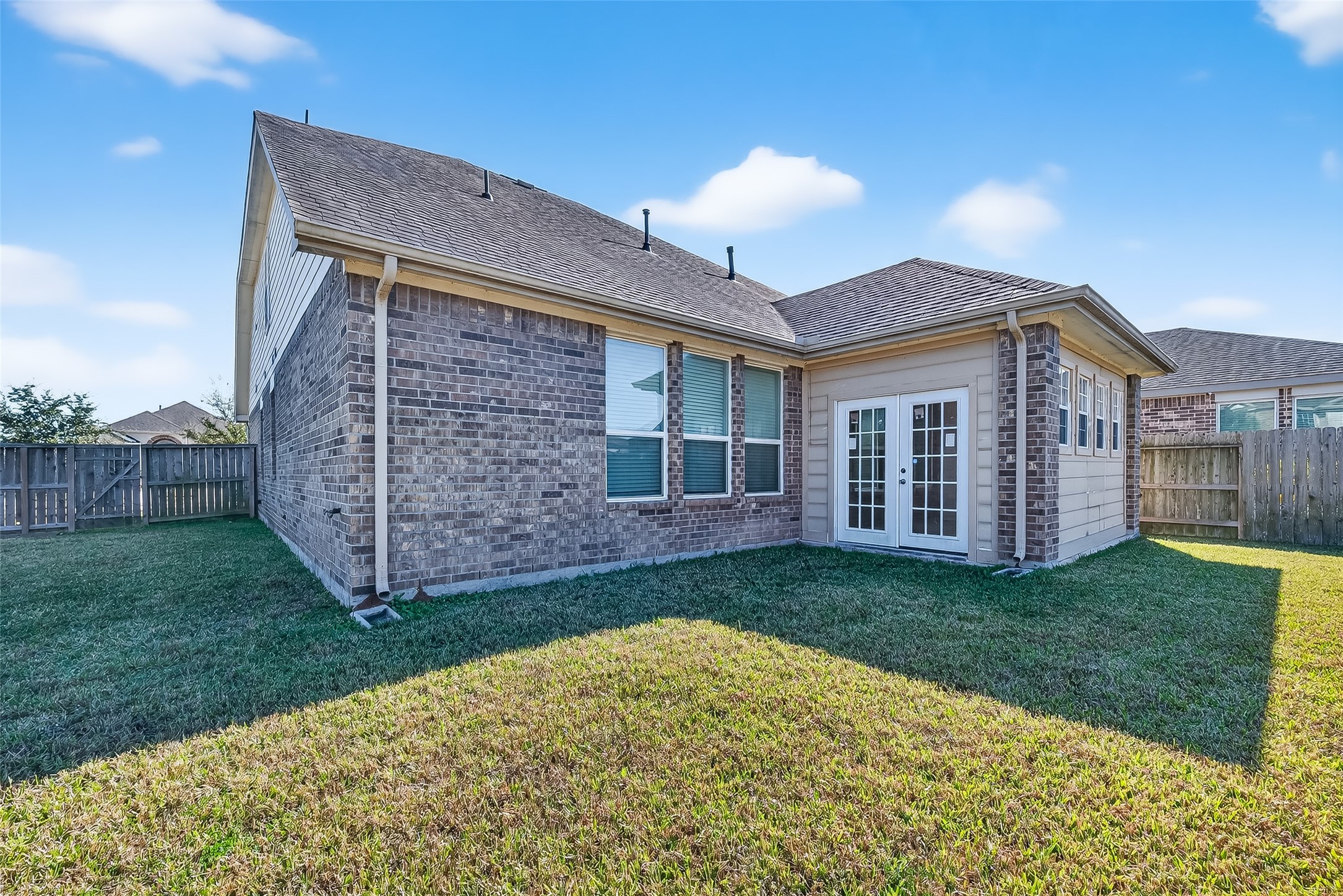 5 Lucas Chase Court Manvel, TX 77578 - Photo 42 of 50 Set within a gated community with lakes, trails, a pool, and clubhouse, this expansive backyard gives you the outdoor space you crave—while staying just minutes from all the shopping, dining, and everyday essentials at Manvel and Pearland Town Centers.