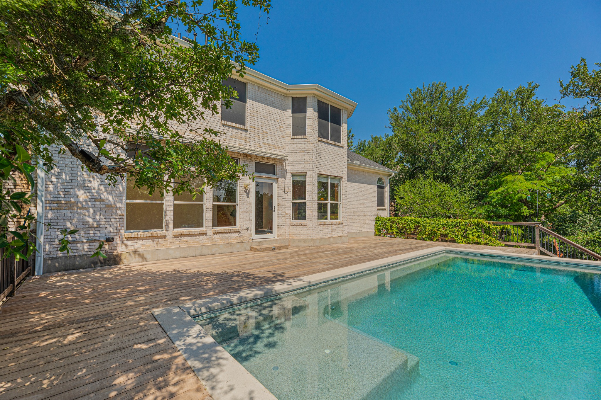 304 River Down Road Georgetown, TX 78628 - Photo 3 of 22 Outdoor living area featuring an in-ground swimming pool with integrated steps, surrounded by a wood-finish deck