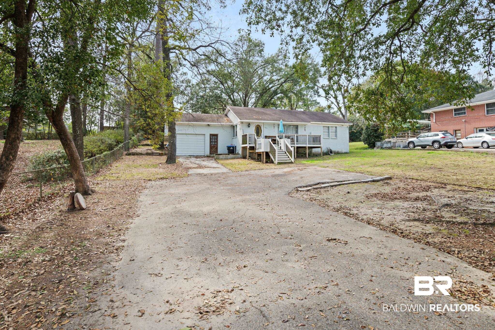 305 Alpine Street Mobile, AL 36611 - Photo 3 of 21 View of front of property with a garage and a front yard