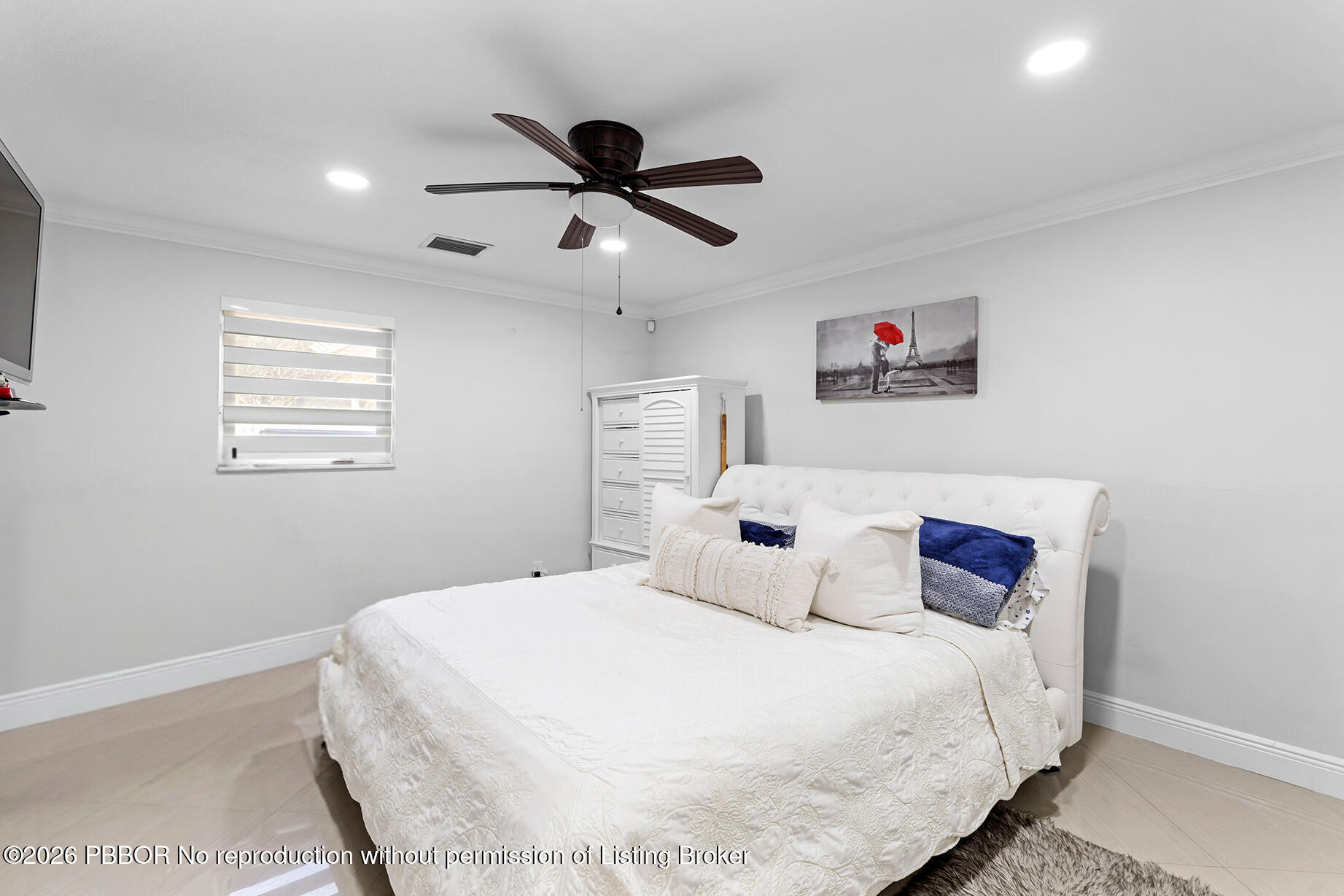 747 Avon Road West Palm Beach, FL 33401 - Photo 9 of 29 a bedroom with a large bed and a chandelier