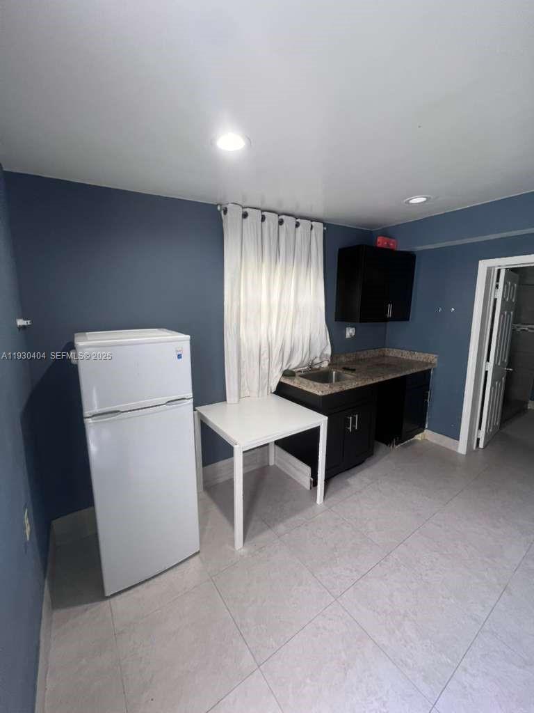 3101 Southwest 14th Street, Unit 1 Fort Lauderdale, FL 33312 - Photo 1 of 6 a living room with furniture a flat screen tv and a table