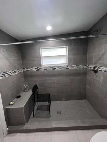 a bathroom with a tub and window