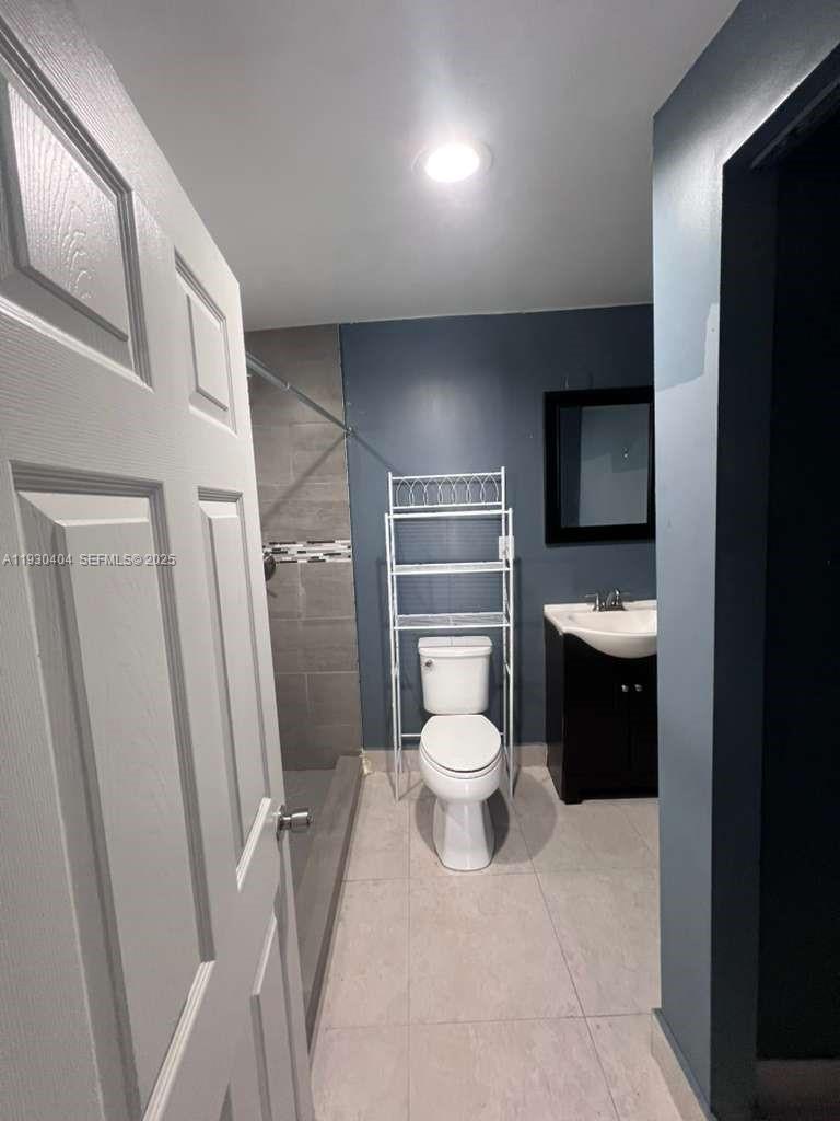 3101 Southwest 14th Street, Unit 1 Fort Lauderdale, FL 33312 - Photo 3 of 6 a bathroom with a toilet sink and a mirror