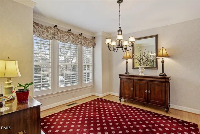 a living room with a table and a chandelier
