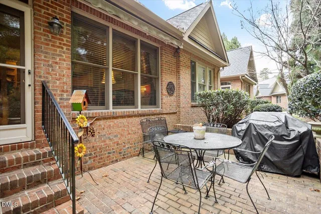 a view of a patio with table and chairs and potted plants