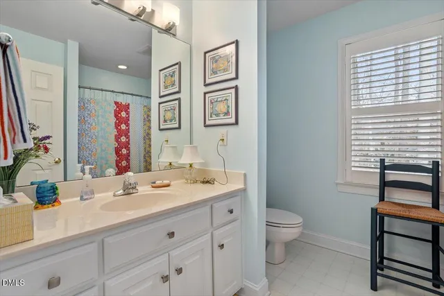 a bathroom with a double vanity sink a toilet and a mirror