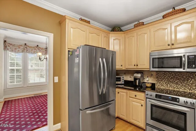 a kitchen with stainless steel appliances a refrigerator stove and microwave