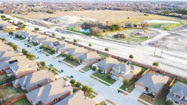 an aerial view of residential houses with outdoor space