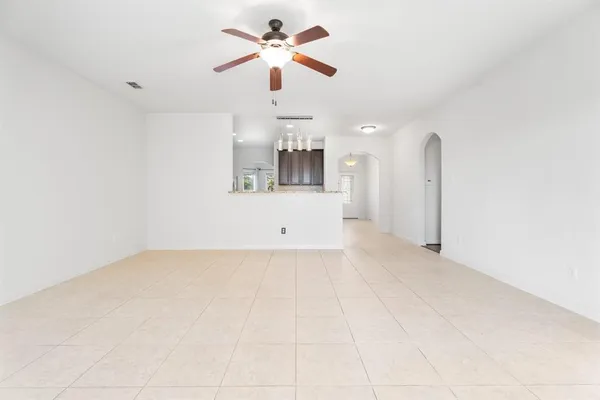 a view of a kitchen with a sink and a chandelier fan