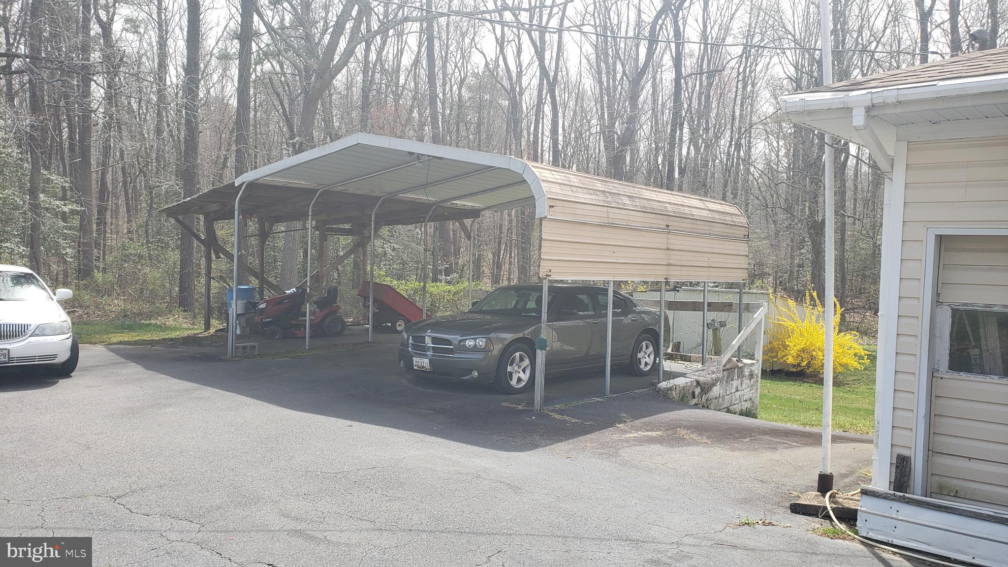 24040 Hollywood Road Hollywood, MD 20636 - Photo 5 of 5 Spacious carport nestled in serene woods.