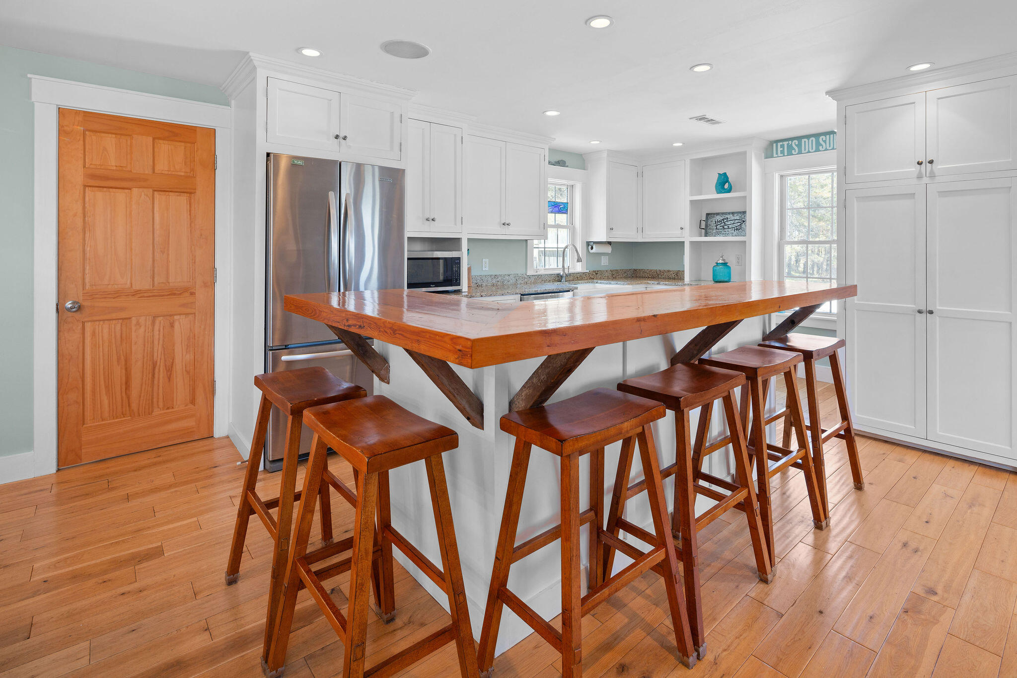 16 Hughes Road Truro, MA 02666 - Photo 14 of 50 a kitchen with stainless steel appliances granite countertop table chairs refrigerator and microwave