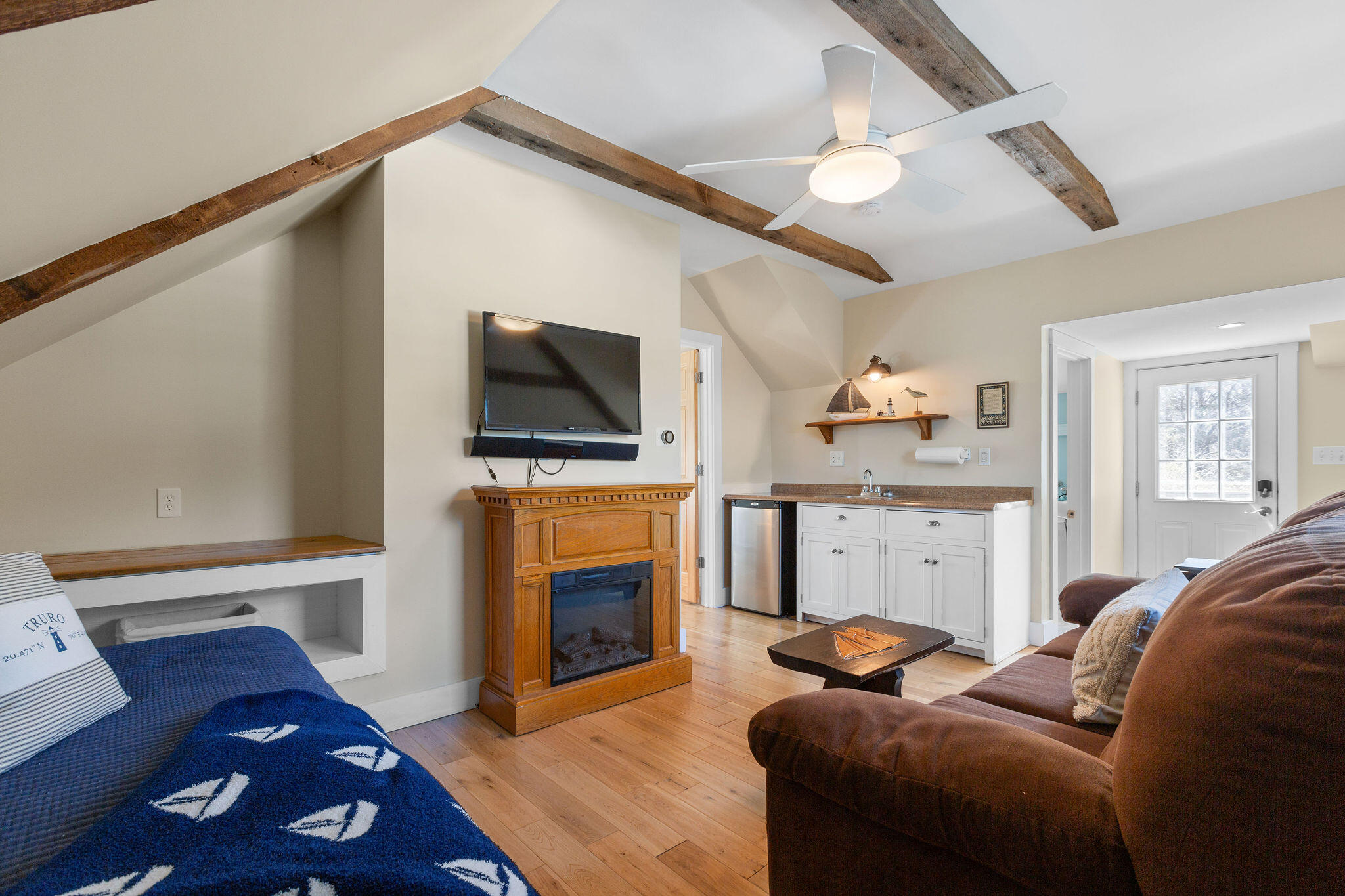 16 Hughes Road Truro, MA 02666 - Photo 30 of 50 a living room with furniture a fireplace and a flat screen tv