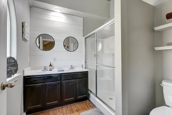 a bathroom with a sink a toilet and a mirror