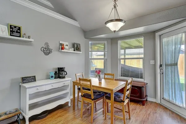 a view of a dining room with furniture window and wooden floor