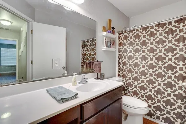 a bathroom with a sink toilet and shower