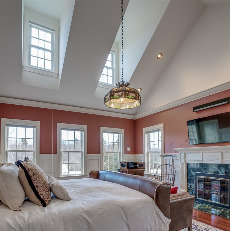 286 Shadyside Avenue Concord, MA 01742 - Photo 13 of 35 a spacious bedroom with a bed and a fireplace