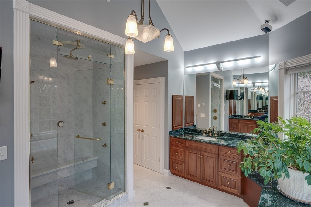 286 Shadyside Avenue Concord, MA 01742 - Photo 15 of 35 a bathroom with a granite countertop sink a mirror and a shower
