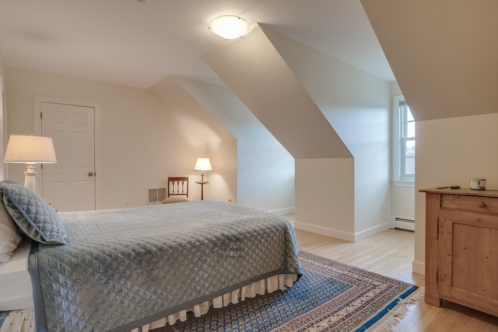 286 Shadyside Avenue Concord, MA 01742 - Photo 23 of 35 a bedroom with a bed and wooden floor