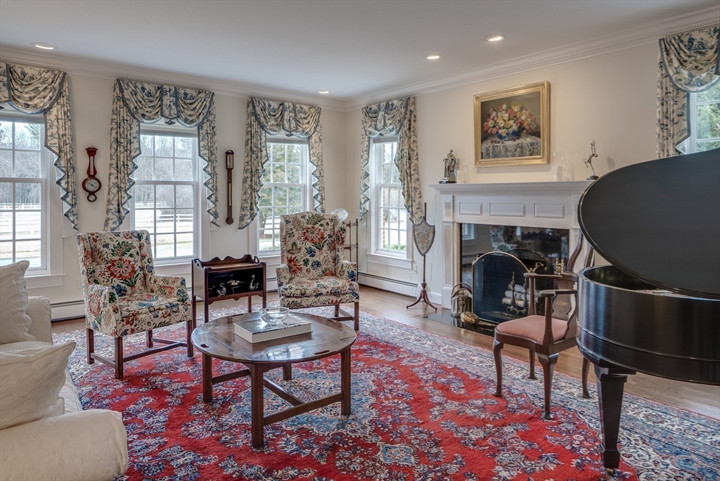 286 Shadyside Avenue Concord, MA 01742 - Photo 10 of 35 a living room with furniture a rug a fireplace and a window