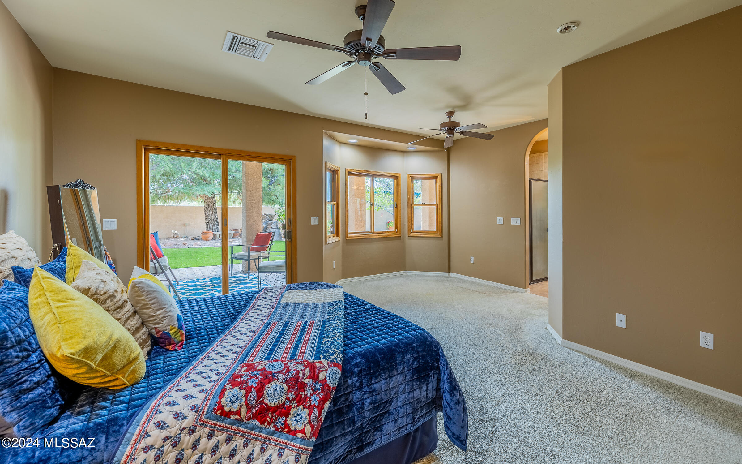 341 Sharon Road Vail, AZ 85641 - Photo 19 of 50 a bedroom with a bed and sliding glass door