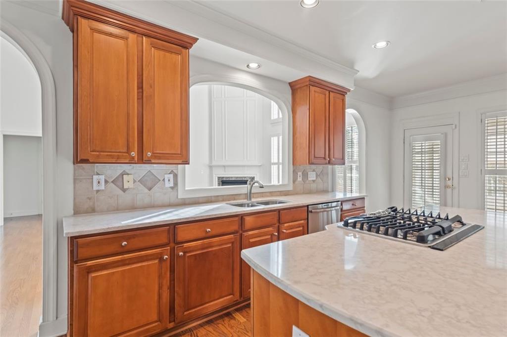 4751 Rosebrook Place Southeast Atlanta, GA 30339 - Photo 13 of 59 a kitchen with stainless steel appliances granite countertop a sink a stove and a wooden cabinets