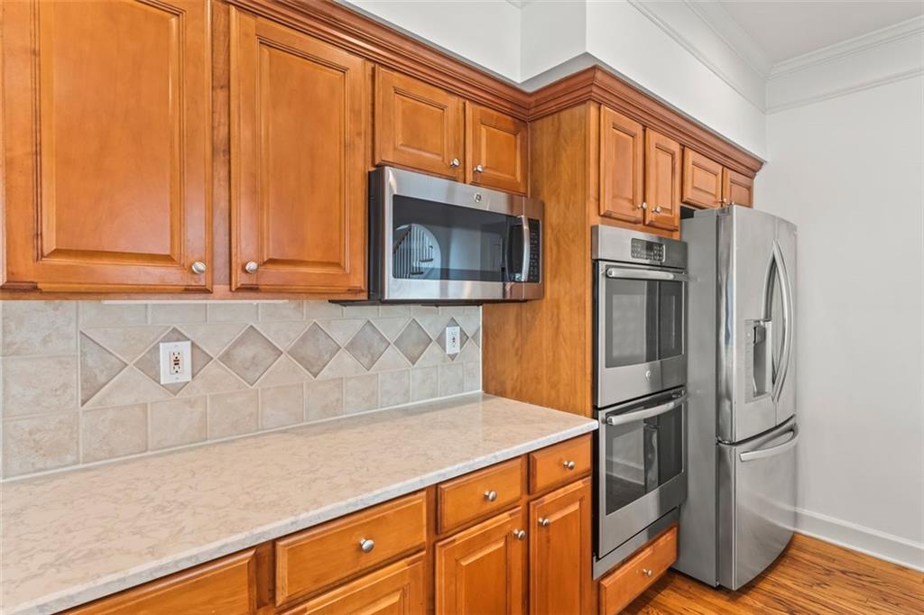 4751 Rosebrook Place Southeast Atlanta, GA 30339 - Photo 14 of 59 a kitchen with stainless steel appliances granite countertop a refrigerator a oven a sink and dishwasher with wooden floor