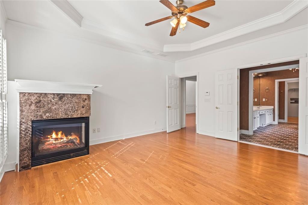 4751 Rosebrook Place Southeast Atlanta, GA 30339 - Photo 24 of 59 a view of an empty room with chandelier fan and fire place